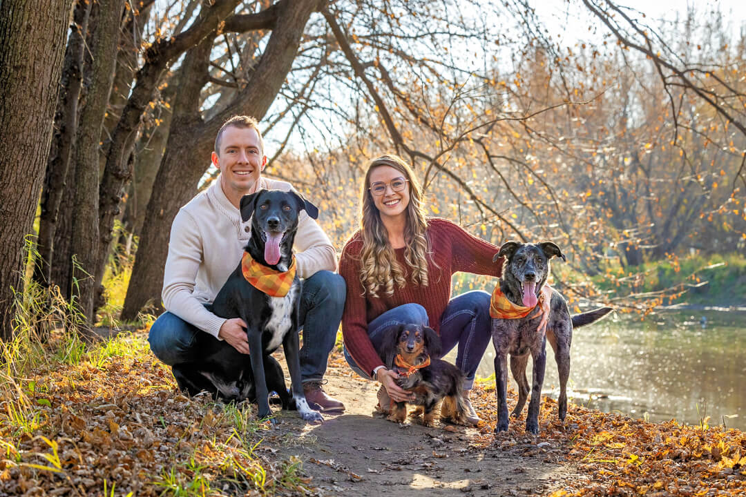 Family photo of mom, dad, and three dogs