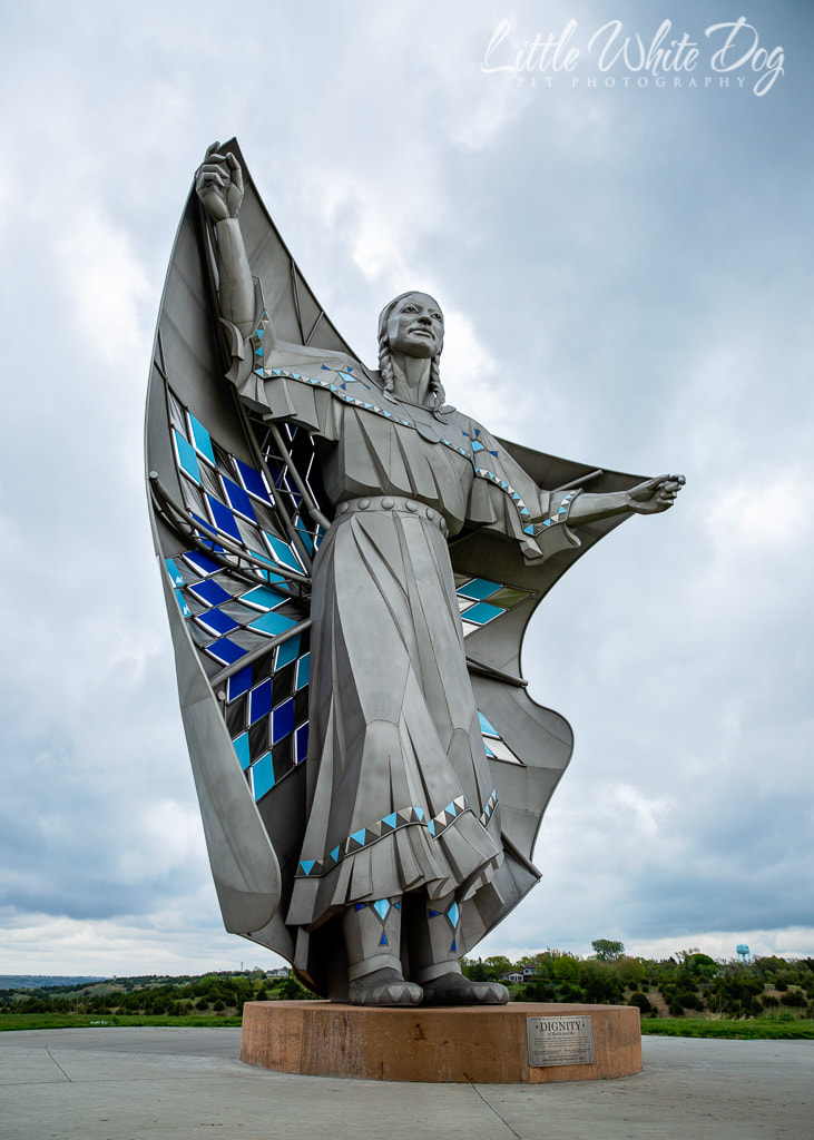 Statue entitled Dignity of a Native American woman holding a star quilt behind her like a flag in Chamberlain SD